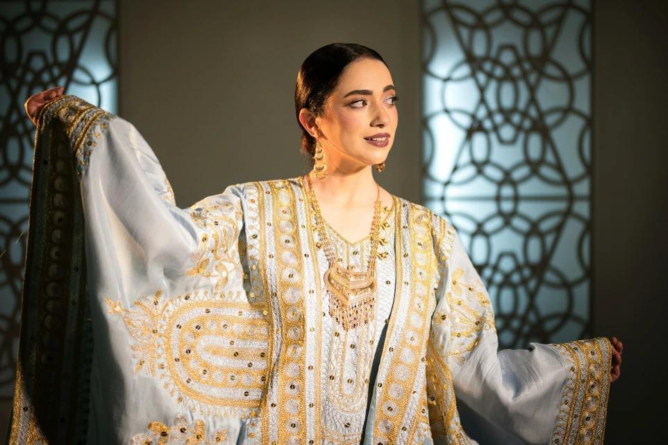 A woman in a light blue ornate traditional dress.
